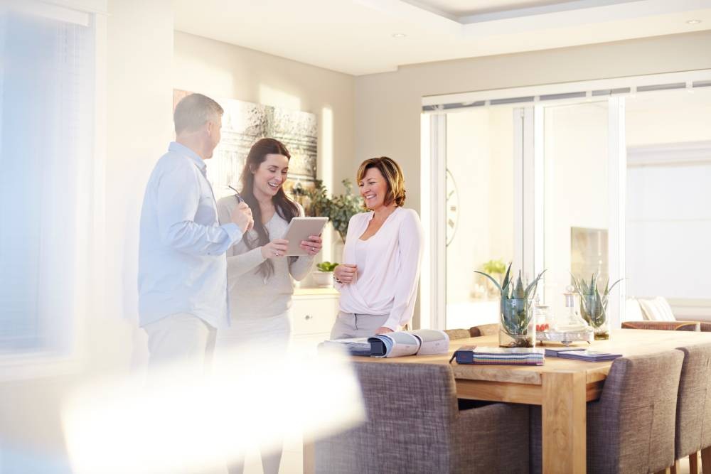 A couple standing with their interior designer in a dining room, getting their in-home consultation at Interior Re-Styling near Council Bluffs, Iowa (IA)