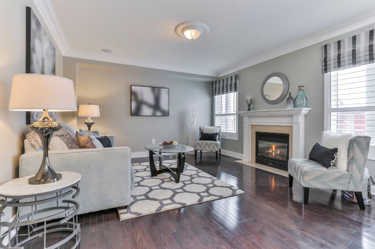 Living room with patterned custom shades and various patterns on rugs, chairs, and art at Interior Re-Styling near Council Bluffs, IA